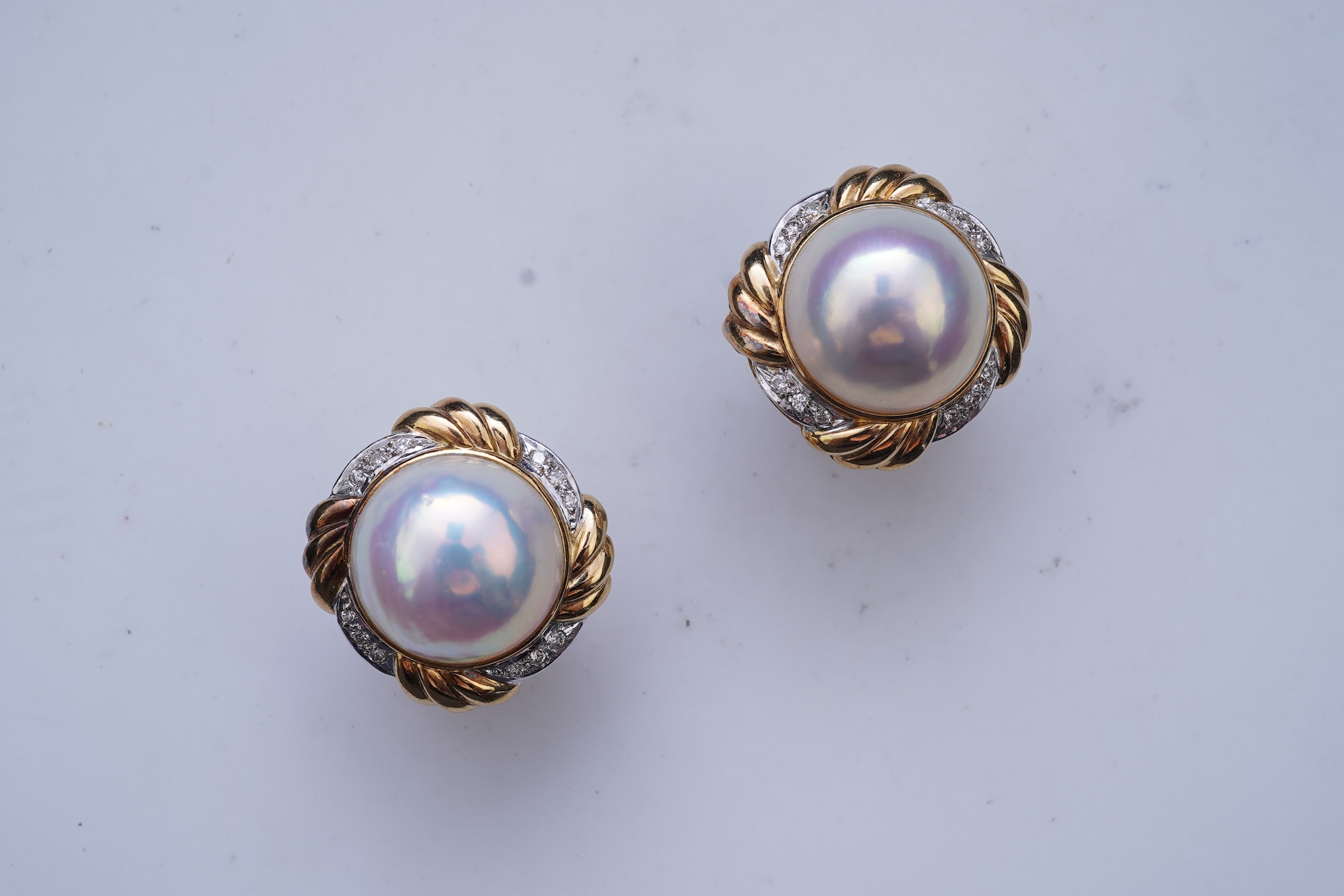 A pair of mabé cultured pearl and diamond earrings